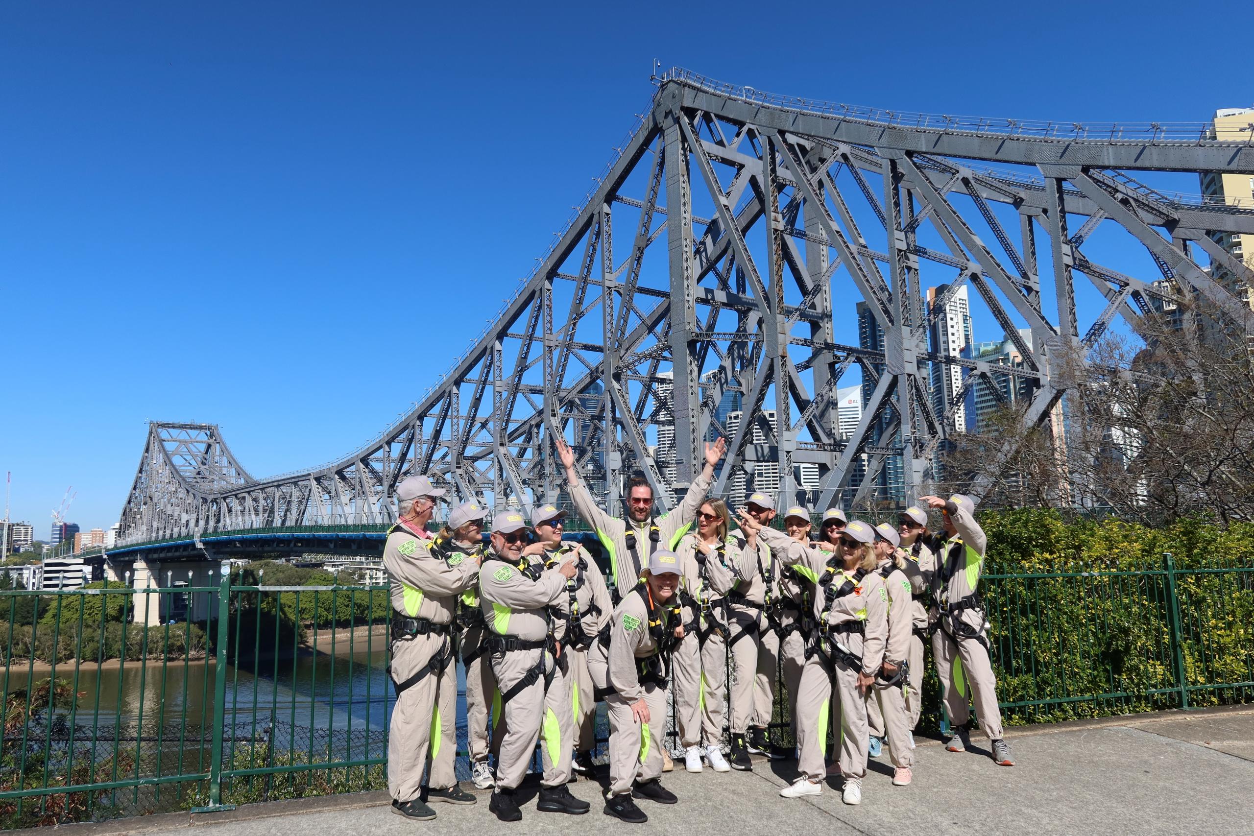 Group of climbers walking along the Story Bridge Adventure Climb walkway high above the Brisbane River